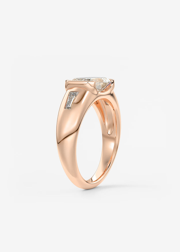 The Lune Trio Emerald Cut Half Bezel Three Stone Engagement Ring with Peekaboo Gallery and Tapered Baguettes#material_rose