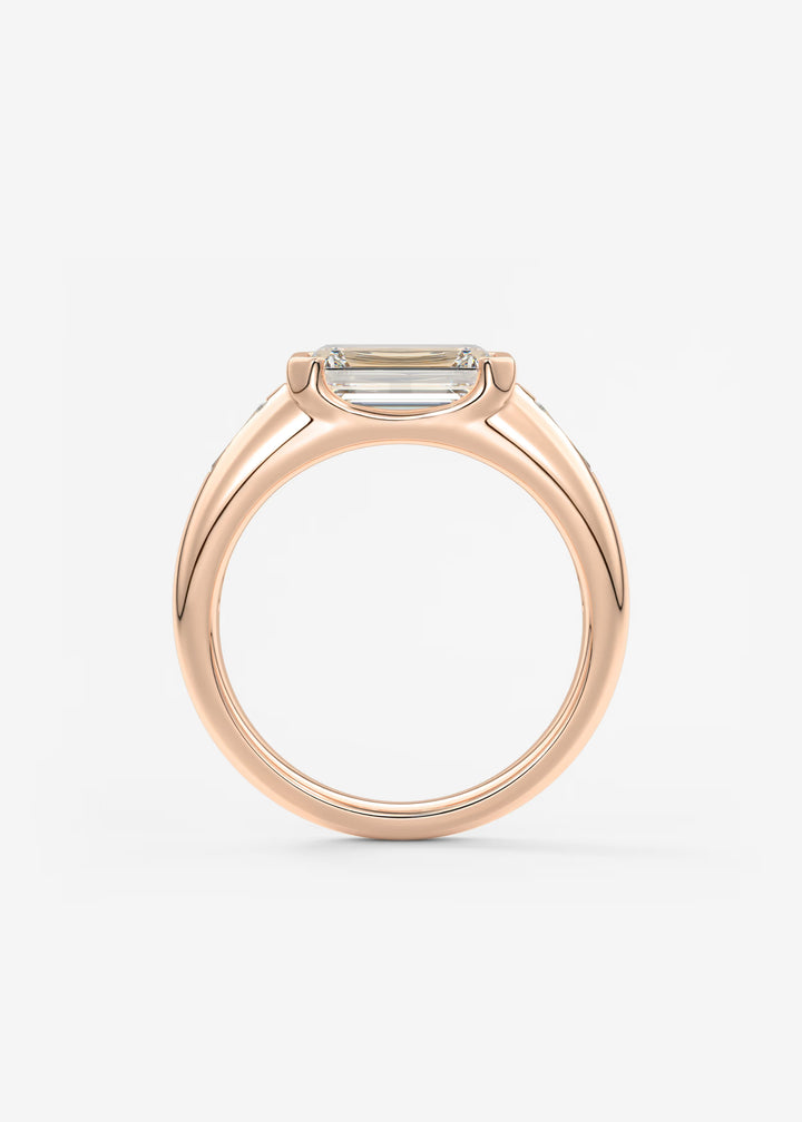 The Lune Trio Emerald Cut Half Bezel Three Stone Engagement Ring with Peekaboo Gallery and Tapered Baguettes#material_rose