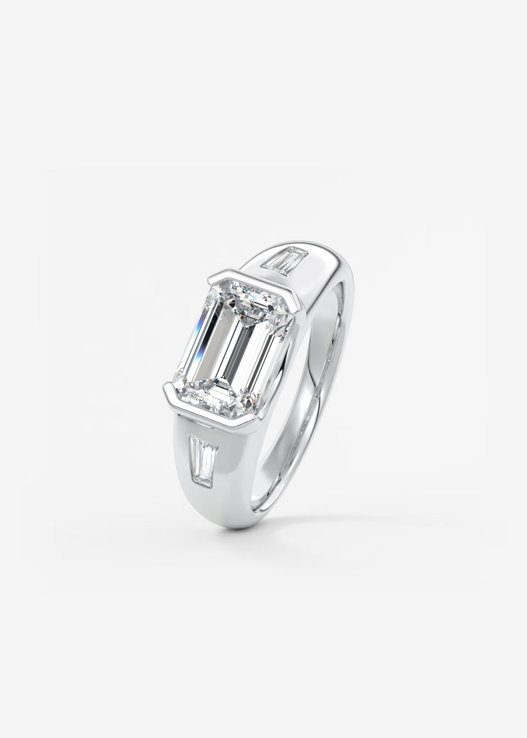 The Lune Trio Emerald Cut Half Bezel Three Stone Engagement Ring with Peekaboo Gallery and Tapered Baguettes#material_white