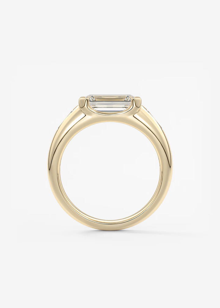 The Lune Trio Emerald Cut Half Bezel Three Stone Engagement Ring with Peekaboo Gallery and Tapered Baguettes#material_gold
