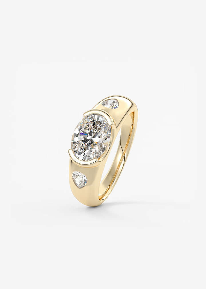The Lune Trio Oval Cut Half Bezel Three Stone Engagement Ring with Peekaboo Gallery and Tapered Baguettes#material_gold