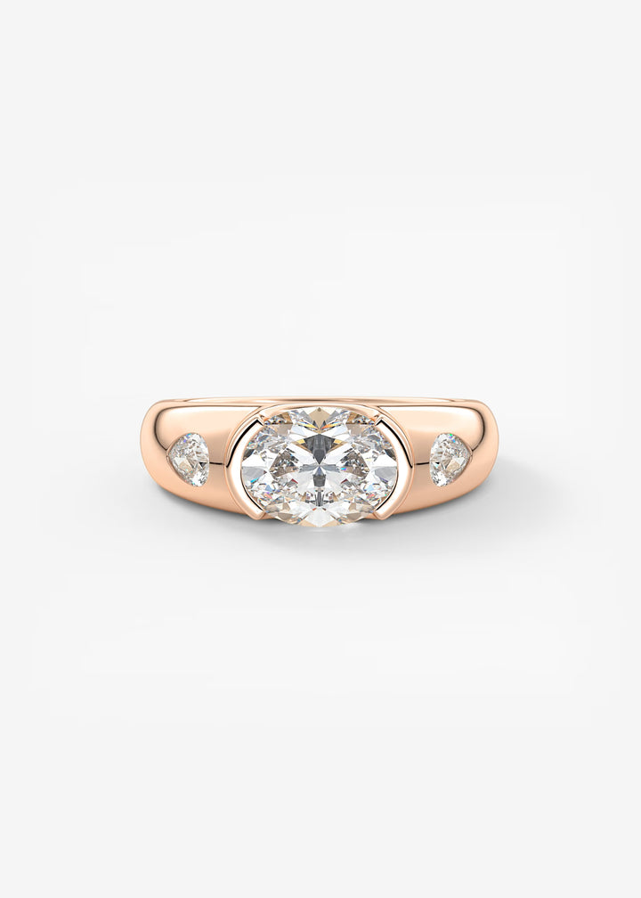 A rose gold ring featuring a large round-cut center stone and two smaller round side stones, set against a clean white background.#material_rose