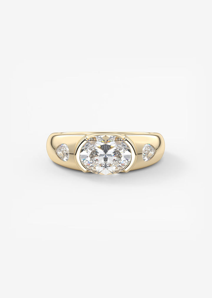 A yellow gold ring featuring a large round-cut center stone and two smaller pear-shaped side stones, set against a plain light gray background.#material_gold