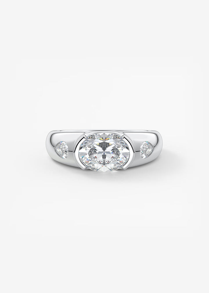 A silver-toned diamond ring with a large round-cut center stone and two smaller marquise-cut side stones, shown on a clean white background.#material_white