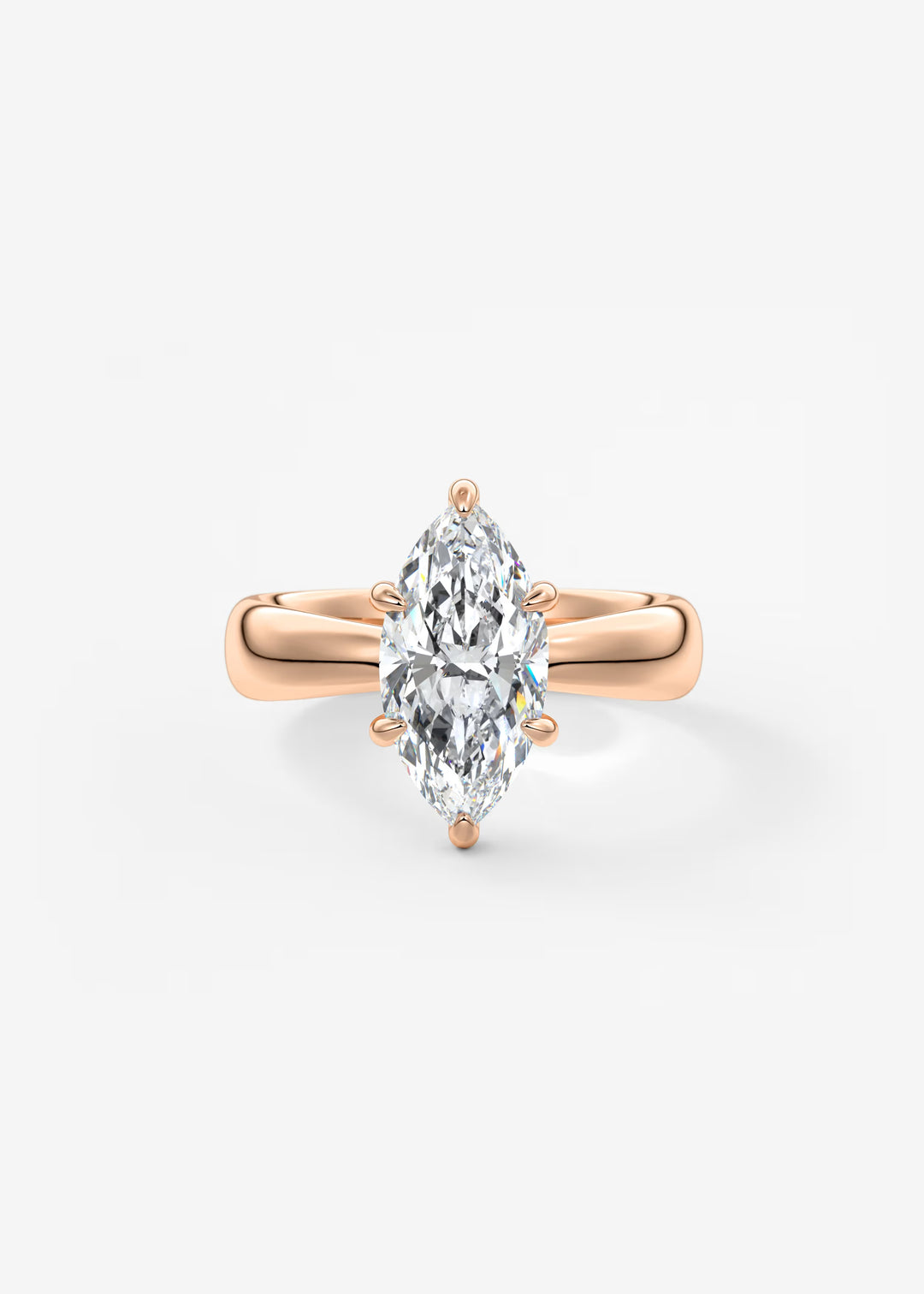 A rose gold ring featuring a marquise-cut clear gemstone in a four-prong setting, centered on a clean white background.#material_rose