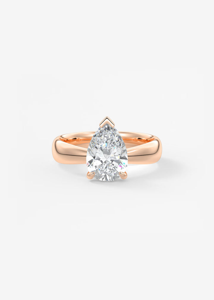 A pear-cut diamond engagement ring set in a rose gold band, centered on a clean white background.#material_rose