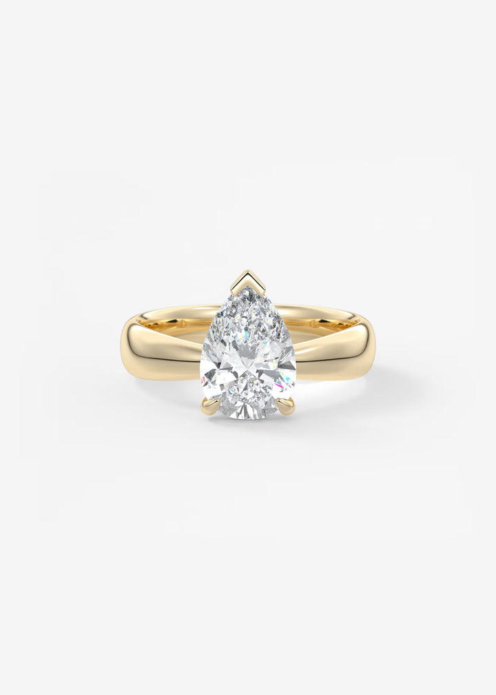 A pear-cut diamond engagement ring set in a yellow gold band, centered on a clean white background.#material_gold