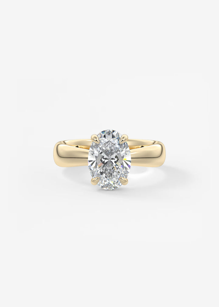 A yellow gold solitaire engagement ring featuring a large oval-cut diamond, set against a clean white background.#material_gold