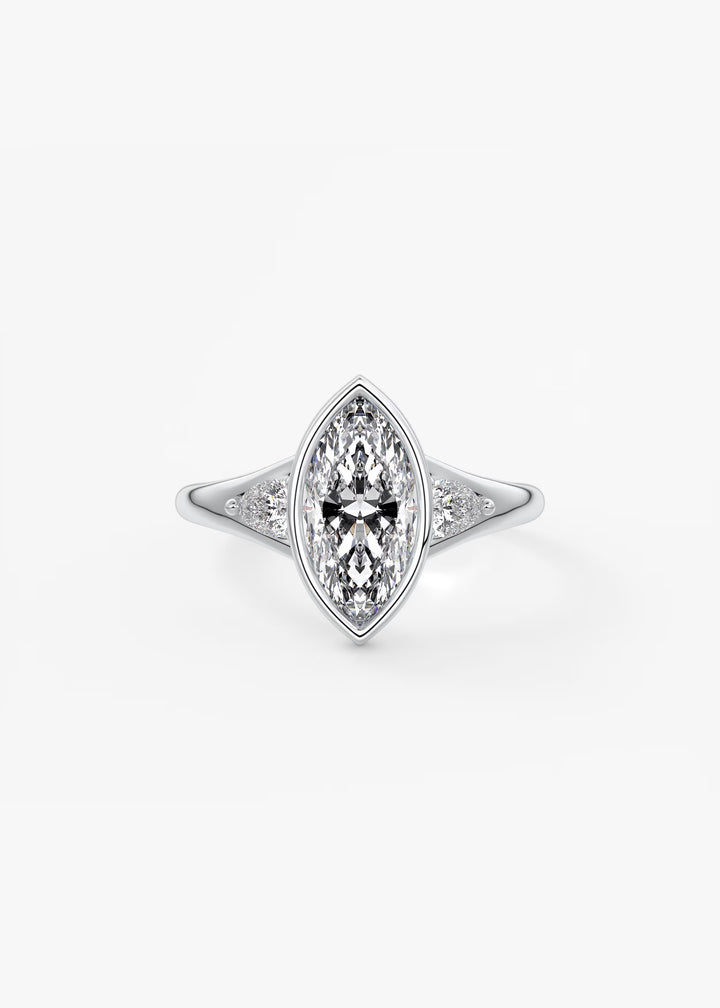 A silver-tone ring featuring a marquise-cut diamond center stone with smaller diamonds set along the shoulders, shown on a clean white background.#material_white