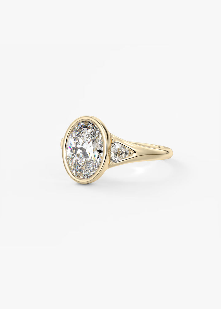 The Solene Bezel Set Oval & Trillion Split Shank Engagement Ring#material_gold