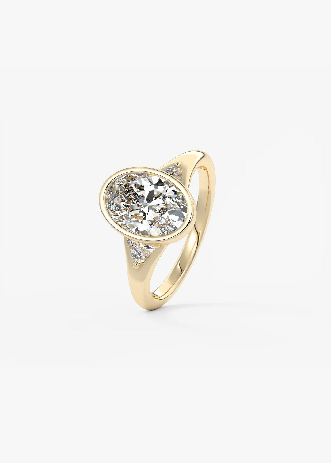 The Solene Bezel Set Oval & Trillion Split Shank Engagement Ring#material_gold