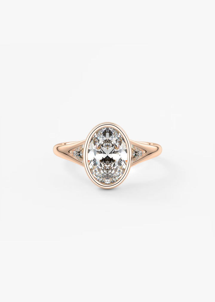 An oval-cut diamond ring in a rose gold setting with small accent diamonds on either side of the band, shown against a plain white background.#material_rose