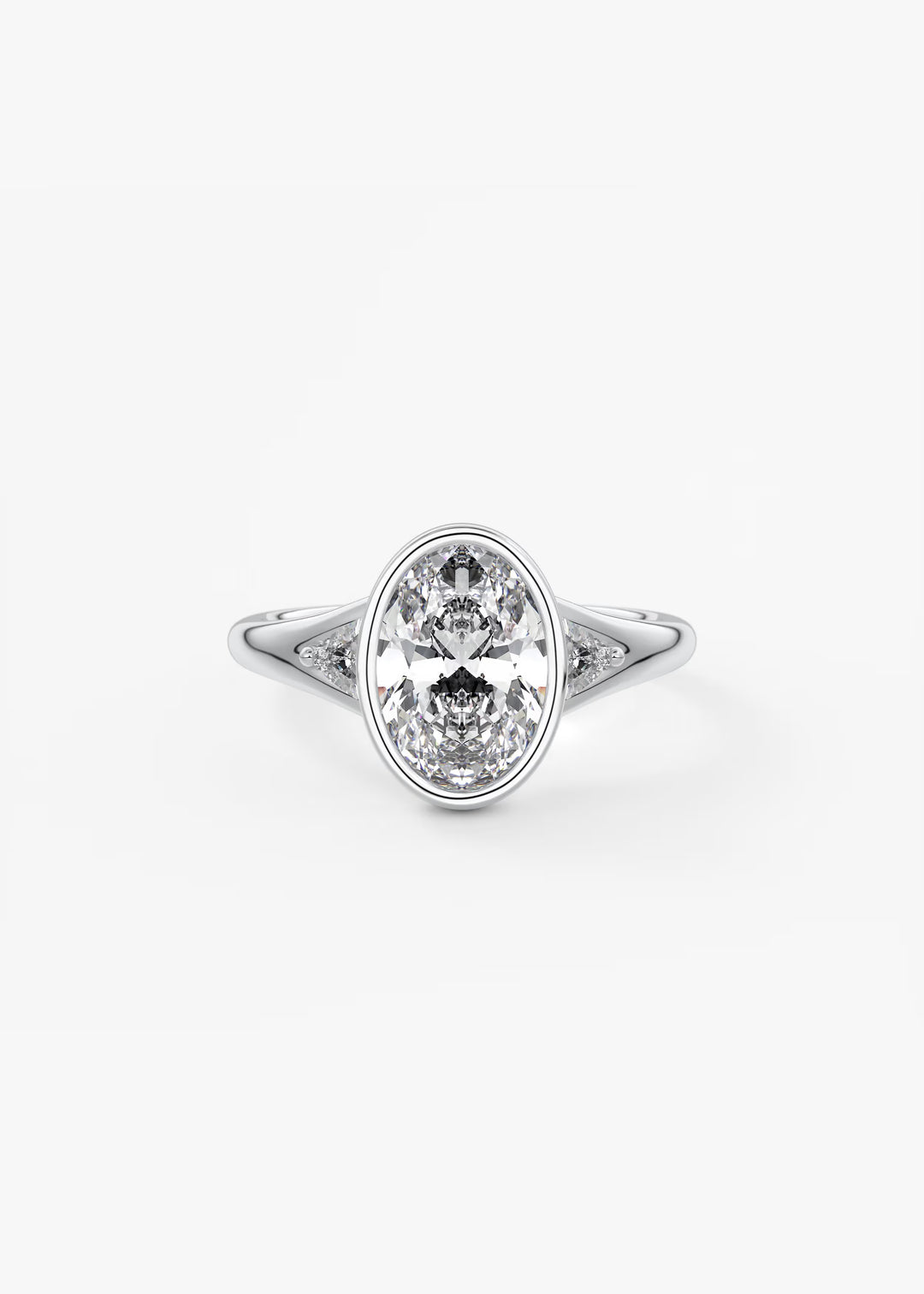 An oval-cut diamond engagement ring with a silver-toned band, photographed on a clean, light gray background.#material_white