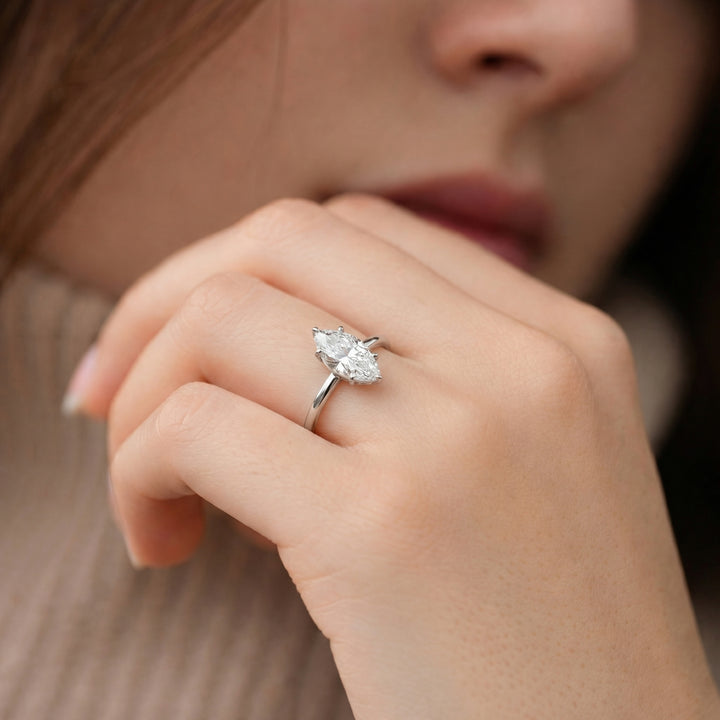 Close-up of a hand wearing a diamond ring with a blurred background #material_white