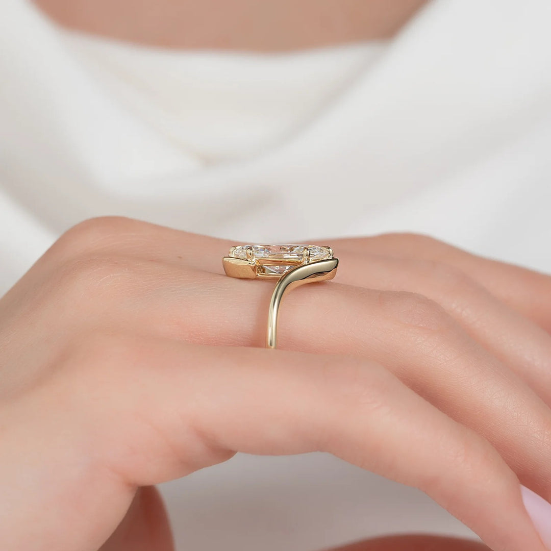 Gold ring with a heart-shaped diamond on a hand against a white background #material_gold