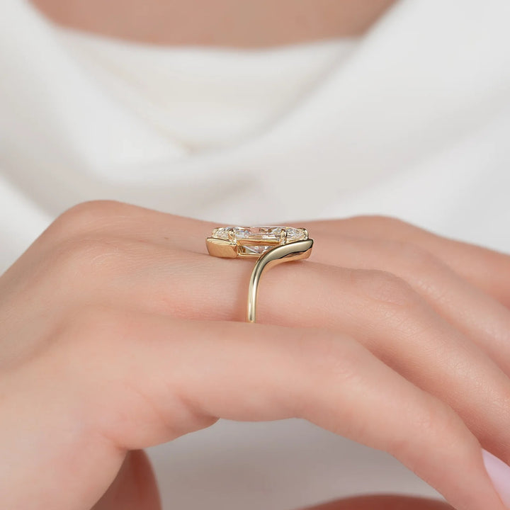 Gold ring with a heart-shaped diamond on a hand against a white background #material_gold