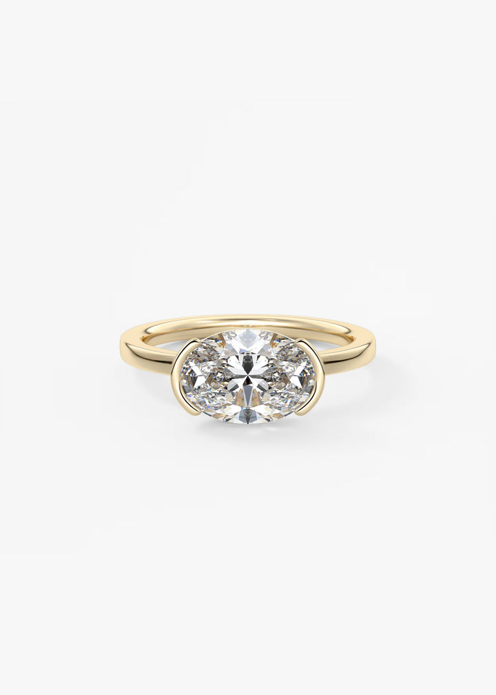 A yellow gold ring featuring a round brilliant-cut diamond in a double-row setting, presented on a clean white background.#material_gold