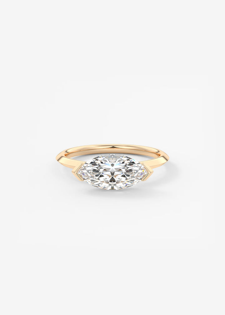 A yellow gold ring featuring a marquise-cut clear gemstone in a prong setting, centered on a clean white background.#material_rose