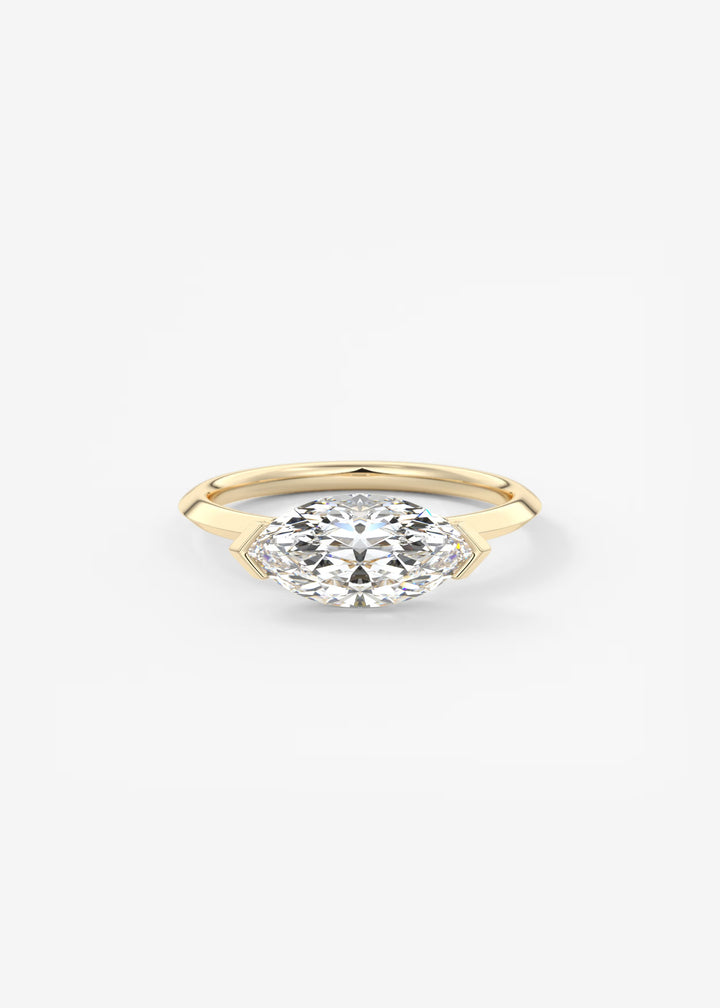 A yellow gold marquise-cut diamond engagement ring on a clean white background.#material_gold