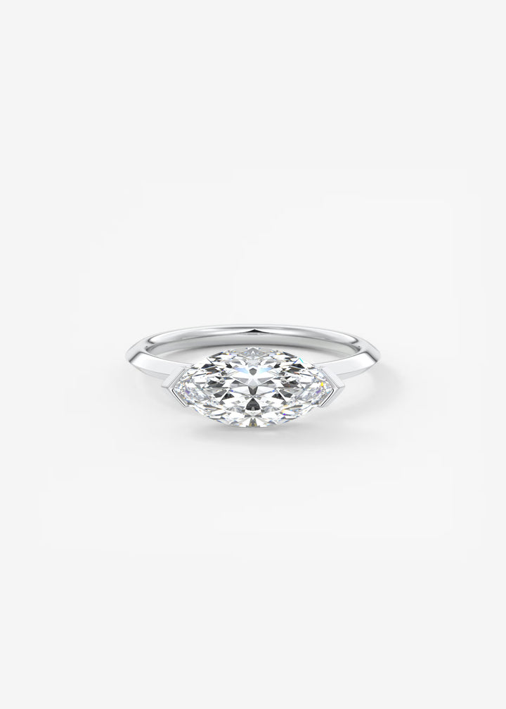 A silver marquise-cut diamond engagement ring on a clean white background.#material_white