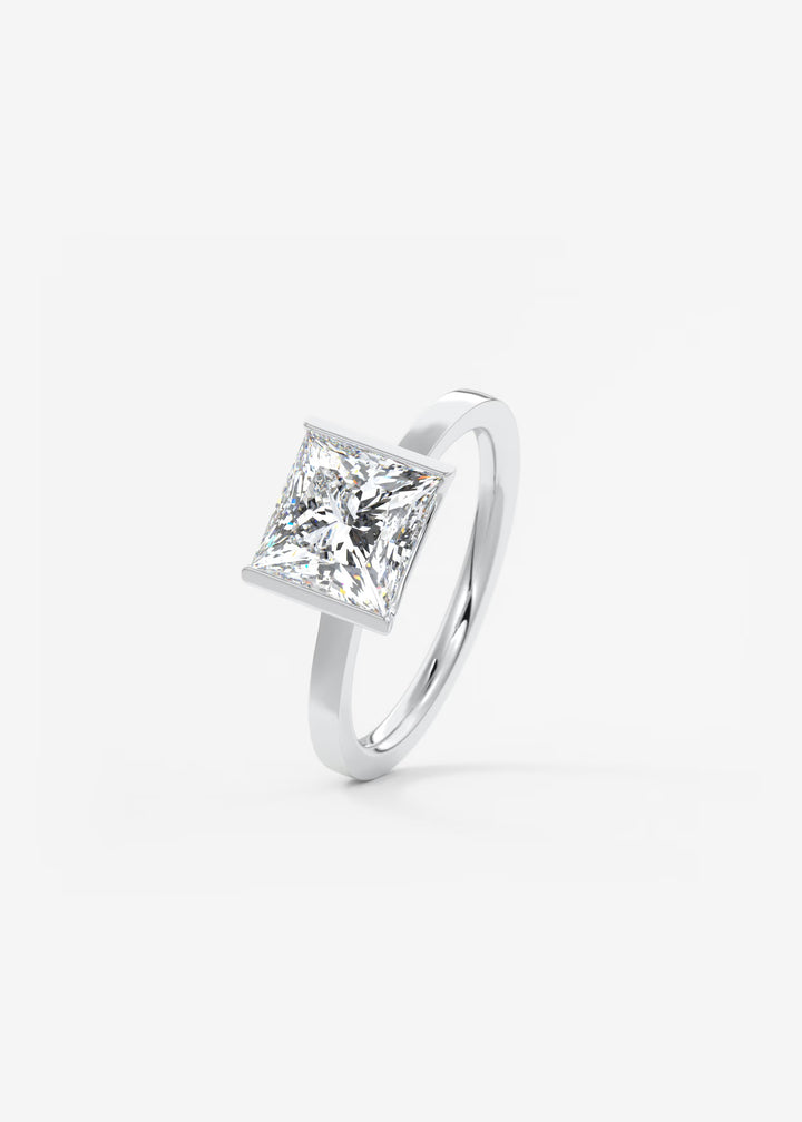 The Vela Princess Cut Engagement Ring with Half Bezel#material_white