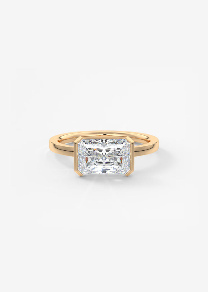 A yellow gold ring featuring a large, square-cut clear gemstone in a prong setting, shown on a clean white background.#material_rose