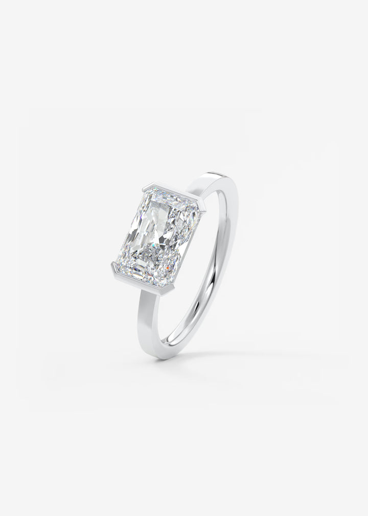 The Vela East West Radiant Cut Engagement Ring with Half Bezel#material_white