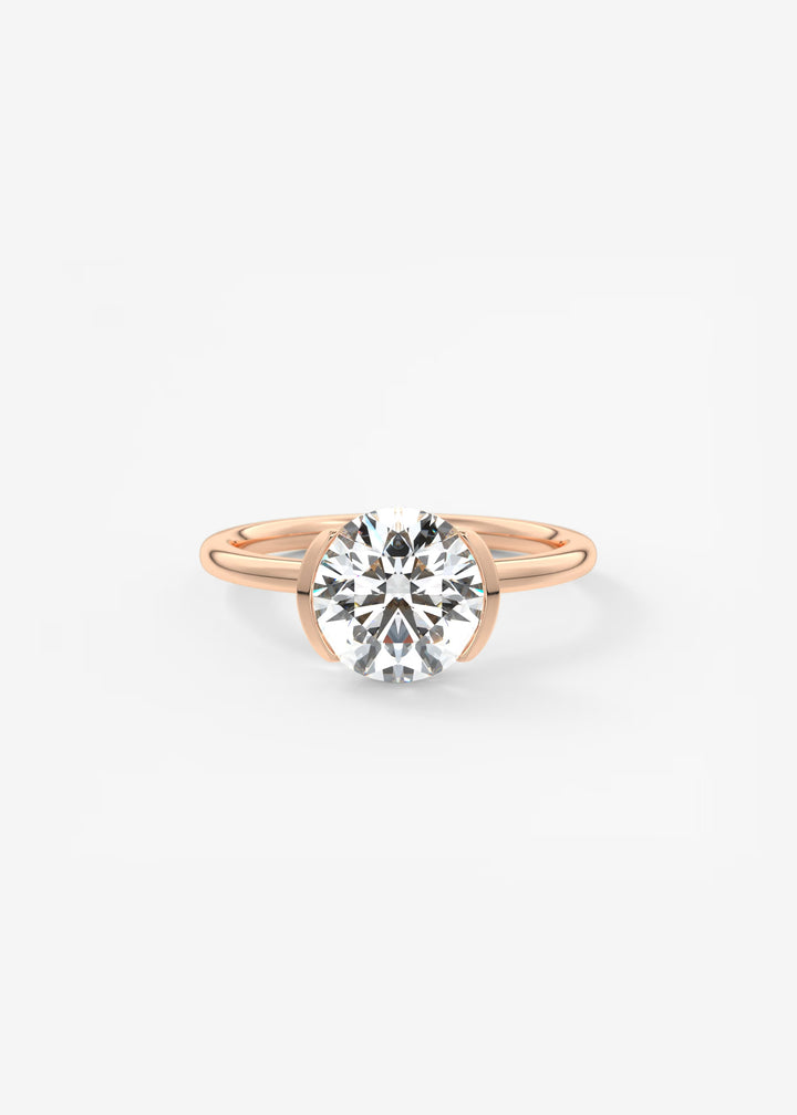 A rose gold solitaire engagement ring featuring a round brilliant-cut diamond center stone, set against a clean white background.#material_rose