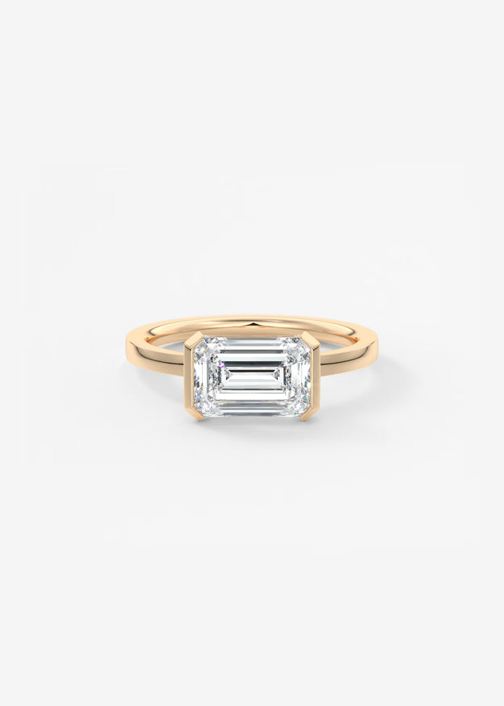 Gold ring with a rectangular diamond on a white background#material_rose