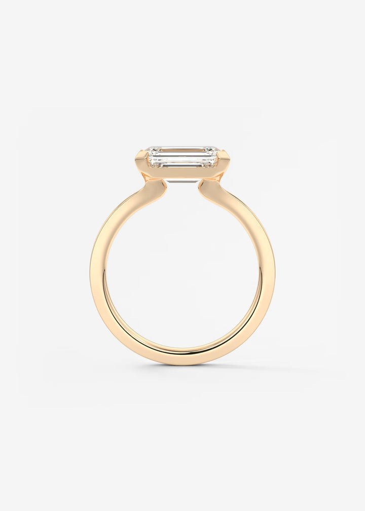 The Vela East West Emerald Cut Engagement Ring with Half Bezel#material_rose