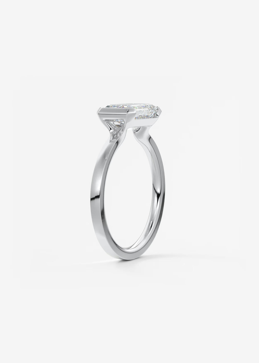 The Vela East West Emerald Cut Engagement Ring with Half Bezel#material_white