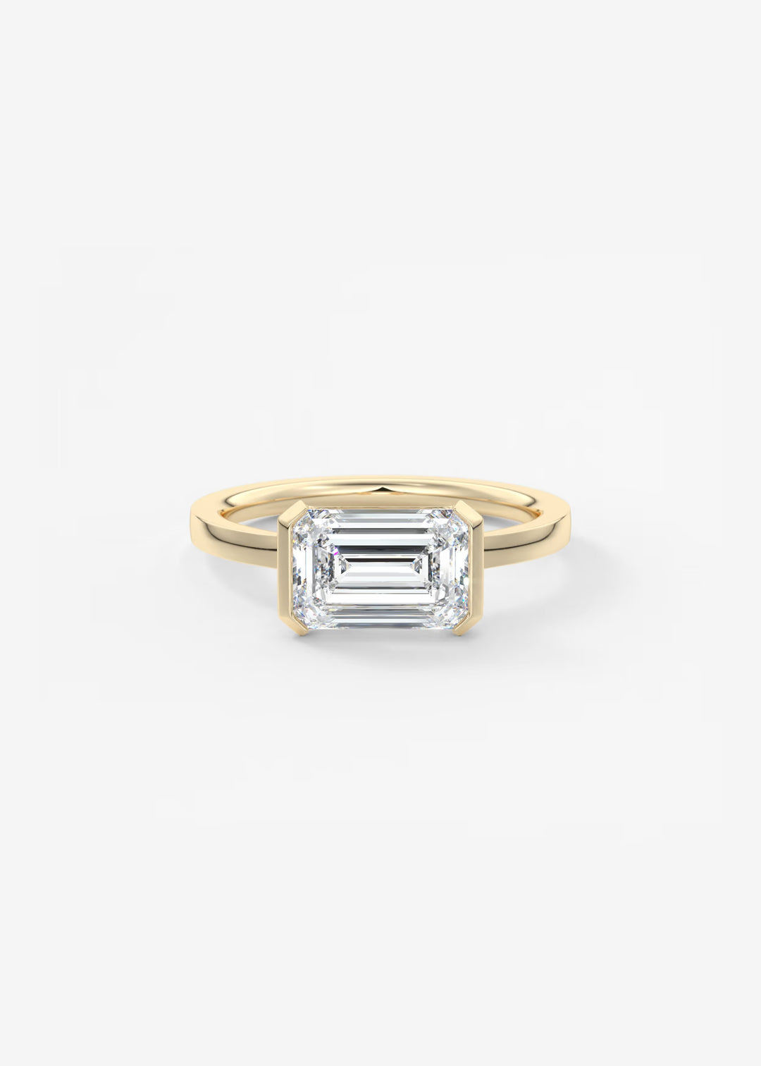 A yellow gold ring featuring an emerald-cut clear gemstone, presented on a clean white background.#material_gold
