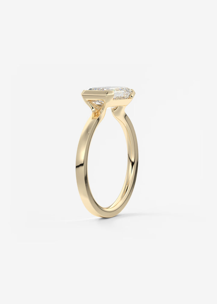 The Vela East West Emerald Cut Engagement Ring with Half Bezel#material_gold